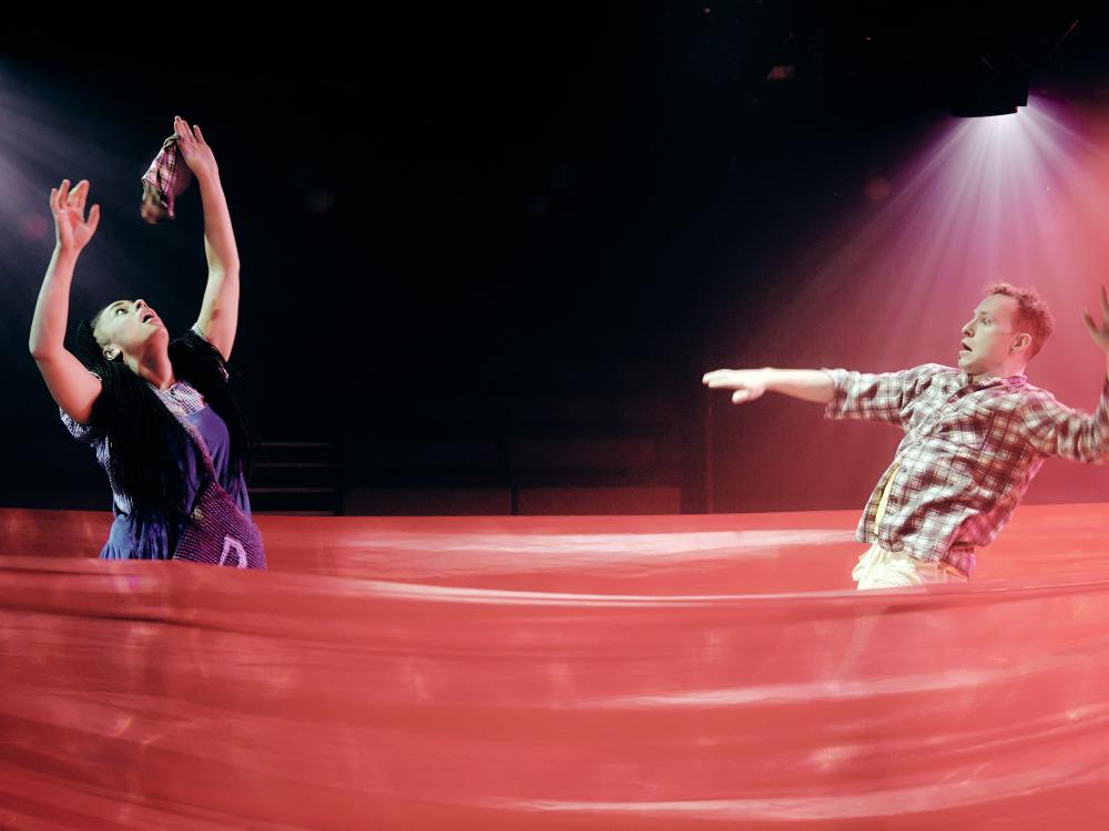 Dorothy tries to grab Toto but his shirt rips in her hand.