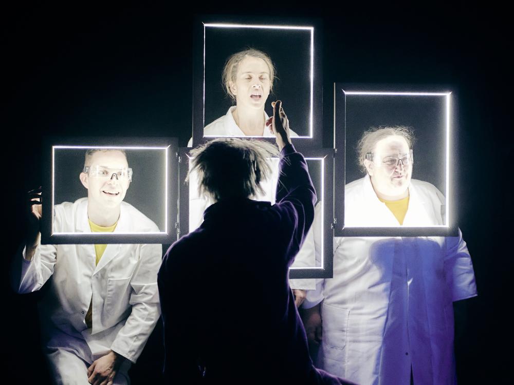 The Wizard of OZ sits at a bank of glowing computer screens.